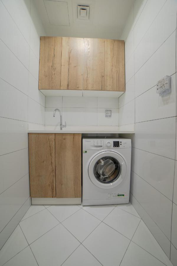 Platinum Coast Hotel Apartments Fujairah Exteriör bild A washing machine in a laundry room